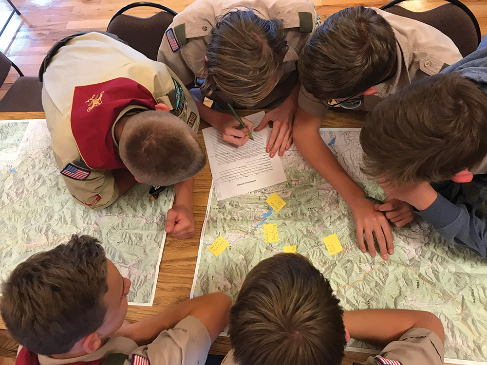 students gathered around map