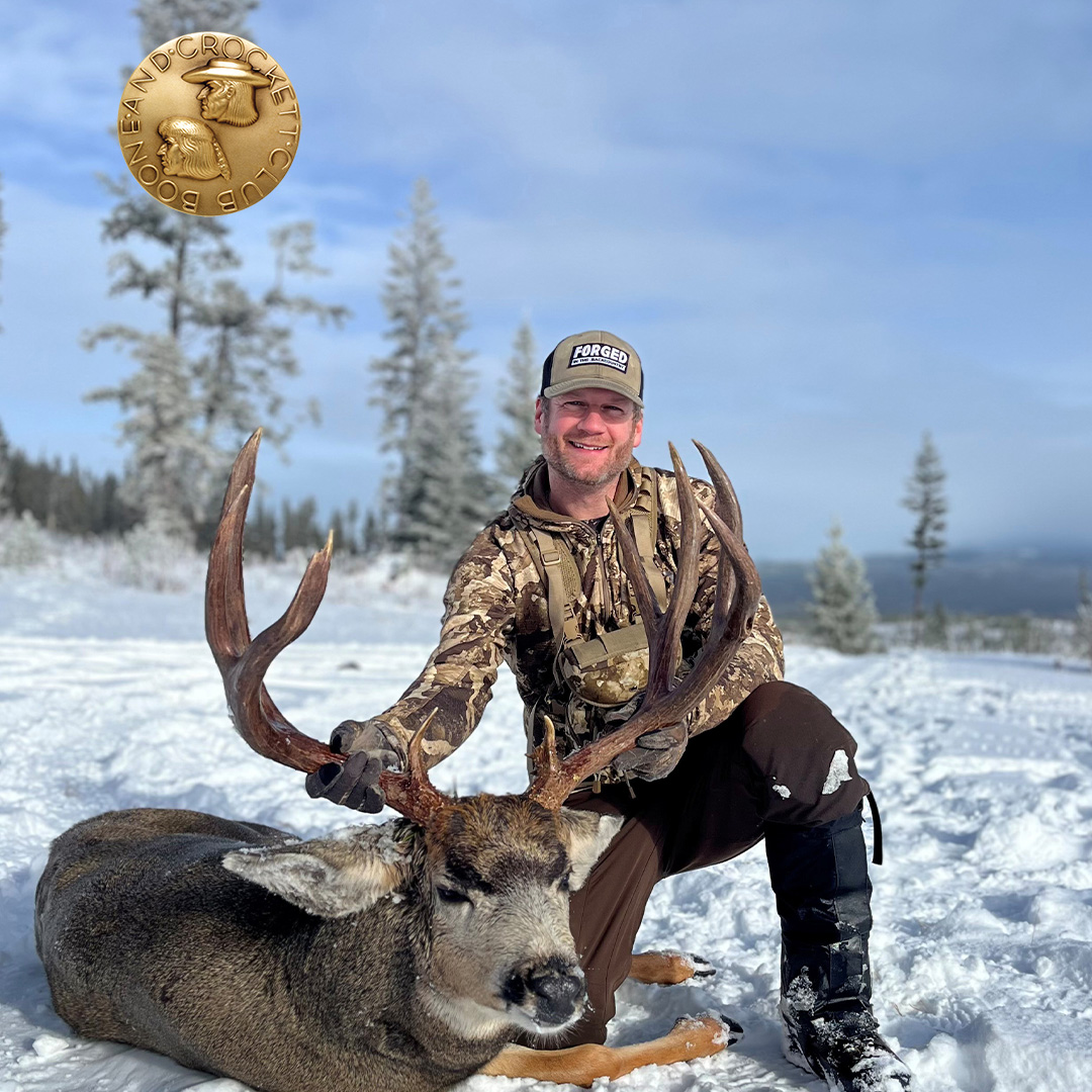 man with mule deer